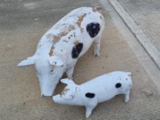 A large decorative pig and piglet, plastic, sow measuring 95cm in length.