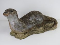 A pre-cast garden statue of an otter, approx 55cm in length.