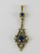 A yellow metal pendant set with seed pearls and blue stones, no apparent hallmark, 3cm inc bale, 1.