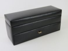 A black leatherette two tier watch box to hold twelve watches.