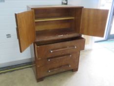 Mid century cabinet having twin doors over three graduated drawers, British made label to back, 83.