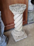 A pre-cast stone barleytwist bird bath, 57cm high.