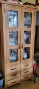 A contemporary oak twin glazed door cabinet having drawers under, 80 x 44.5 x 183cm.