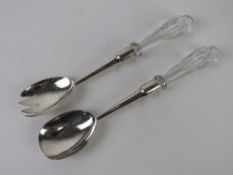 A pair of HM silver salad servers having cut glass handles, hallmarked Birmingham 1905.