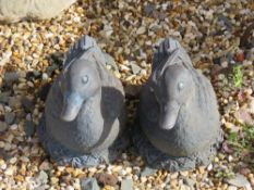 A pair of resin duck garden ornaments, each 28cm in length.