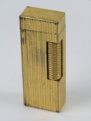 A c1980s Dunhill Rollagas gold plated lighter.