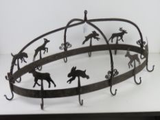 A wrought iron farmhouse style kitchen utensils hanger decorated with deer and rabbits,