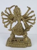 A brass South Asian many armed deity figurine standing approx 25cm high.