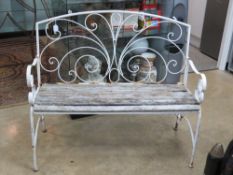 A metal framed white painted folding garden bench.