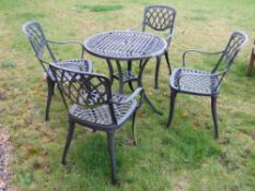 A green painted aluminium bistro table and four chairs.
