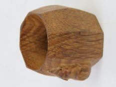 A Robert Mouseman Thompson oak napkin ring, carved with signature mouse.