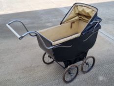 An early 20th century dolls pram by Rabairn retailed by A Watts & Sons Northampton.