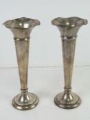 A pair of HM silver bud vases having fluted rims and weighted bases standing 17.5cm high.