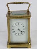 A five glass brass cased carriage clock having swing handle over, with key.