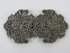 White metal nurses buckle in pierced foliate design.