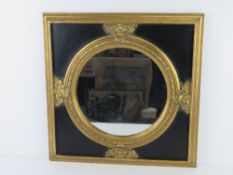A round wall mirror in black and gold painted contemporary neoclassical style fram 50 x 50cm