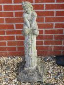 A pre-cast garden ornament in the form of a girl sat upon a short column, 82cm high.
