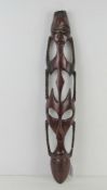 A contemporary wooden wall mask carving measuring 55cm in length.
