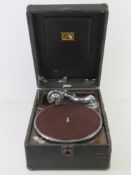 A vintage HMV Record player in travel case.