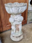 A pre-cast stone planter raised over cherub stand, 58cm high.
