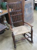 A cane seated fireside chair having later rockers.