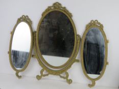 A brass framed tryptic dressing table mirror aperture, 62cm at highest.