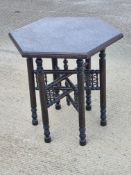 A 19th century Moroccan carved six-leg folding table, 52 x 52 x 58cm.
