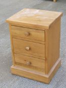 A contemporary oak three drawer bedside table, 38 x 45 x 65cm.