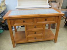 A contemporary marble top butchers block type kitchen island.