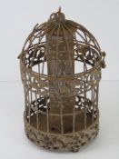A bird feeder with cage over.
