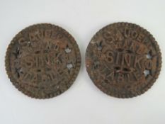 A pair of fireside cast iron pan stands each marked 'saucepan stand for sink or table' each