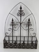 An ironwork wall hanging Gothic style arched back plant holder, 48.5cm wide.