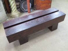 A low Railway sleeper type bench measuring 115cm in length
