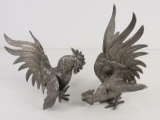 A pair of silver plated table centrepiece fighting cockerels