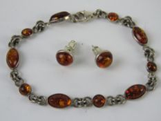 A suite of silver and Baltic amber jewellery being stud earrings and bracelet.