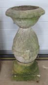 A pre-cast stone bird bath standing approx 104cm high.