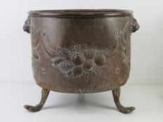 A copper fireside coal bucket having repoussé decoration,