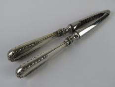 A pair of nut crackers having HM silver handles, London import hallmark.