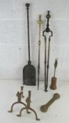 A large brass fireside companion set comprising poker and tongs with associated shovel and other