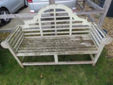 A garden bench having shaped back and scroll arms, approx 168cm wide.