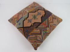 A tapestry type cushion.