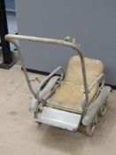 A vintage collapsible dolls pram.