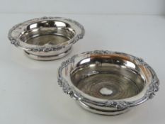 A pair of ornate silver plated wine coasters, 17.5cm dia.
