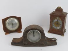 Three assorted wooden cased mantle clocks.