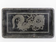 A black lacquered Chinese tray having silvered dragon design upon, 56.3cm wide.