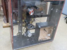 A magic Lantern projector in wooden case with perspex sides for display, 77.5cm high, 75cm wide.