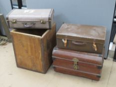 A metal trunk, two vintage suitcases and a vintage tea crate. Four items.