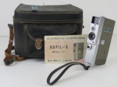 A Kopil-8 Model IC 8mm movie camera with paperwork and case.
