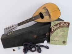 A vintage Mandolin in leatherette case, approx 61cm in length.