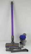 A Dyson Cordless vacuum, with accessories, no charger, two batteries.
